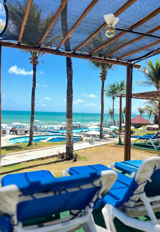 Beachfront sun loungers with ocean view at El Aram Imirá Resort